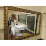 An ornate gilt framed rectangular wall mirror