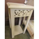 A modern white painted occasional table with under tier