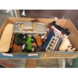A box containing an assortment of farm animals, toy cars,