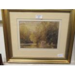A framed and glazed watercolour of a country lake scene signed bottom left