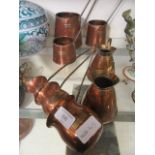 A selection of brass and copper jugs to include brandy, rum, whisky etc.