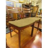 A mid-20th century drop leaf table together with a set of four similar matching chairs