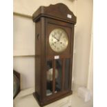 A mid-20th century oak drop dial wall clock