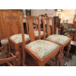 A set of four mid-20th century oak dining chairs