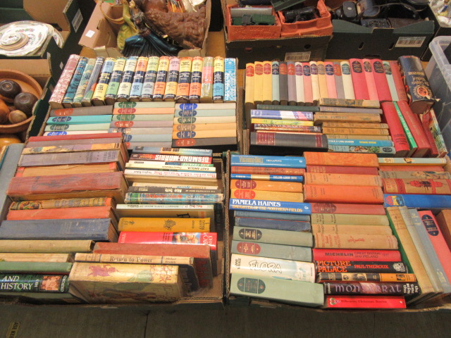 Four trays of hardback books,