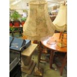 A gilt metal standard lamp together with a matching table lamp