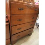 A mid-20th century oak veneered chest of four drawers