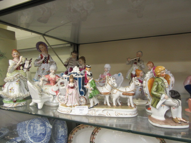 A selection of continental ceramic models of musicians, ladies, horse and carriages etc.