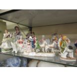 A selection of continental ceramic models of musicians, ladies, horse and carriages etc.