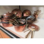 A quantity of brass and copper cooking pans