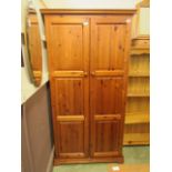 A modern pine two door wardrobe