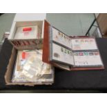 A box containing coinage, first day covers, stamps,