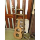 A set of wooden stepladders together with a guitar body shape