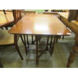 A small mid-20th century gate leg table with barley twist supports