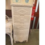 A white painted wicker five drawer chest