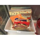 A tray containing an assortment of LPs and 45RPM records to include Fats Domino
