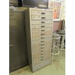 An industrial metal chest of fifteen drawers