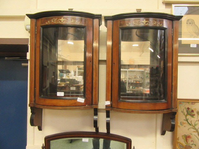 A pair of Edwardian rosewood inlaid mirror back wall hanging bow fronted cabinets (A/F)