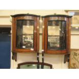 A pair of Edwardian rosewood inlaid mirror back wall hanging bow fronted cabinets (A/F)
