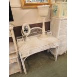 A white painted wicker dressing table together with a small wicker mirror and planter