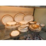 A part Bridgewood dinner set with gold fruit design comprising of meat plates, bowls, tureens,