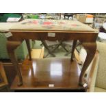 A walnut cabriole legged footstool with needlework seat