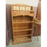 A modern pine wine rack with tiled back