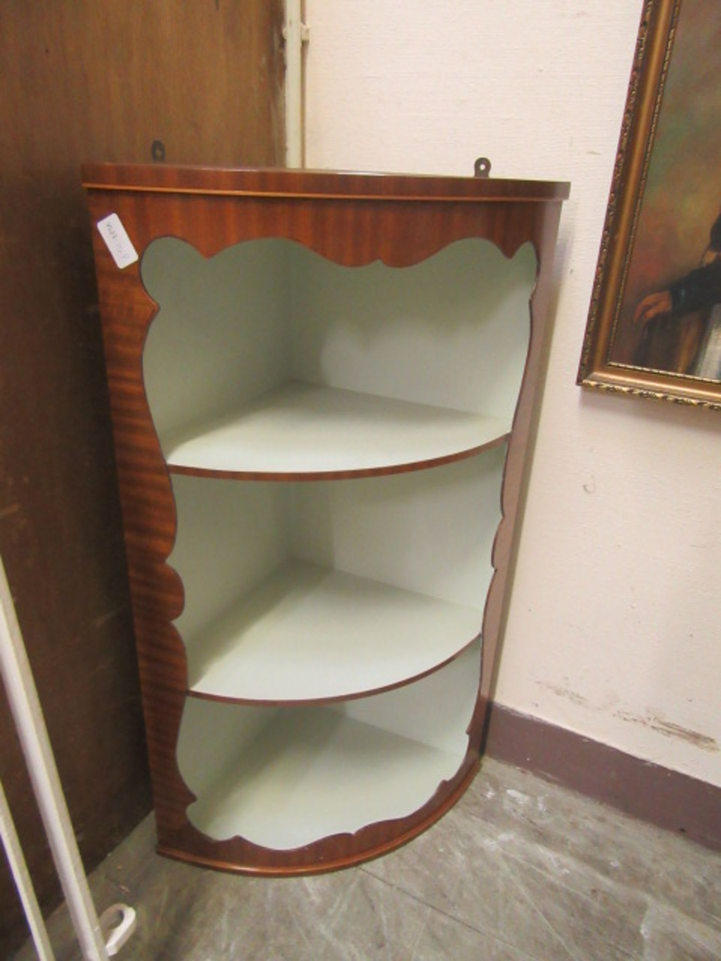 A reproduction mahogany wall hanging bow fronted corner cupboard