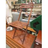 A stained pine folding chair