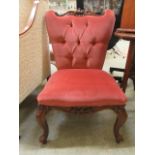 A reproduction Victorian style nursing chair upholstered in a button red velvet