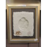 A framed baby elephant footprint in papier mache with elephant dung by Sheila Cooper