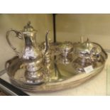 A plated oval gallery tray together with a four piece plated coffee set