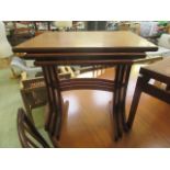 A nest of three mid-20th century teak occasional tables