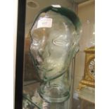A glass wig stand