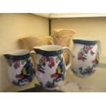 Three graduated floral decorated pouring jugs together with a pair of mid-20th century handled