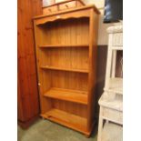 A modern pine full height bookcase