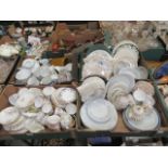 Four trays of decorative ceramic tableware to include cups, saucers, plates,