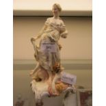 A continental figurine of young lady with children marked KPM to base