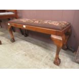 A reproduction walnut and beech stool on cabriole legs with ball and claw feet