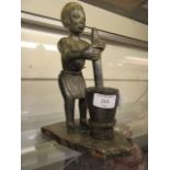 A carved stone figure of African boy