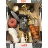 A box containing brushes, wooden napkin rings, ceramic lion, opera glasses, brass candle stick,