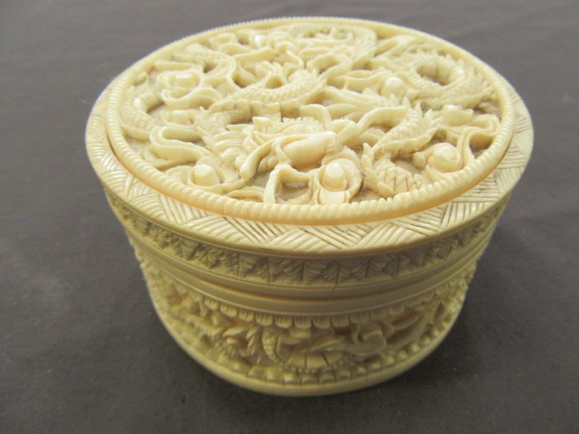 A 19th century Chinse carved lidded ivory pot containing two other ivory items CONDITION
