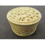 A 19th century Chinse carved lidded ivory pot containing two other ivory items CONDITION