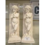 A pair of moulded plaster figures 'PHILOSOPHVS PARVVS'