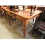 A farmhouse style pine dining table minus drawer