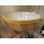 A yellow ceramic mixing bowl