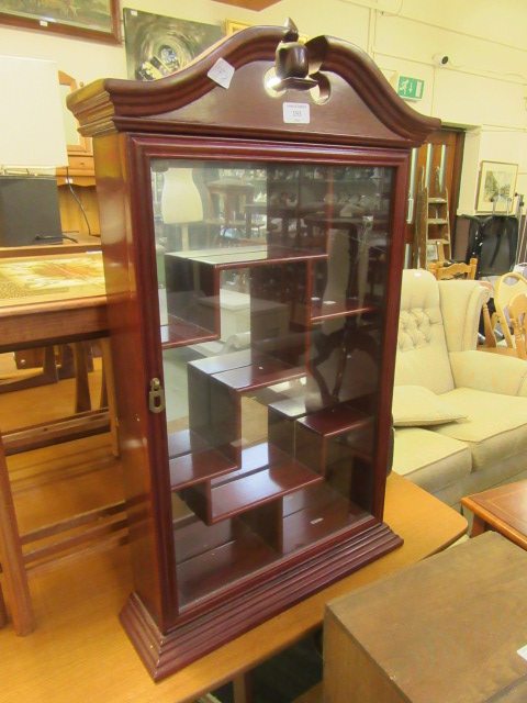 A reproduction rosewood effect wall mounted glazed display cabinet