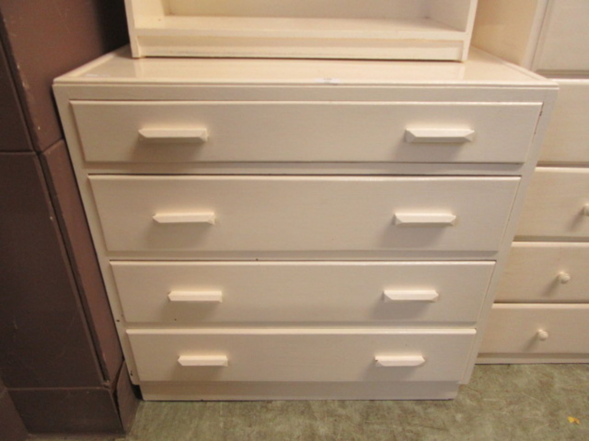 A white painted chest of four drawers