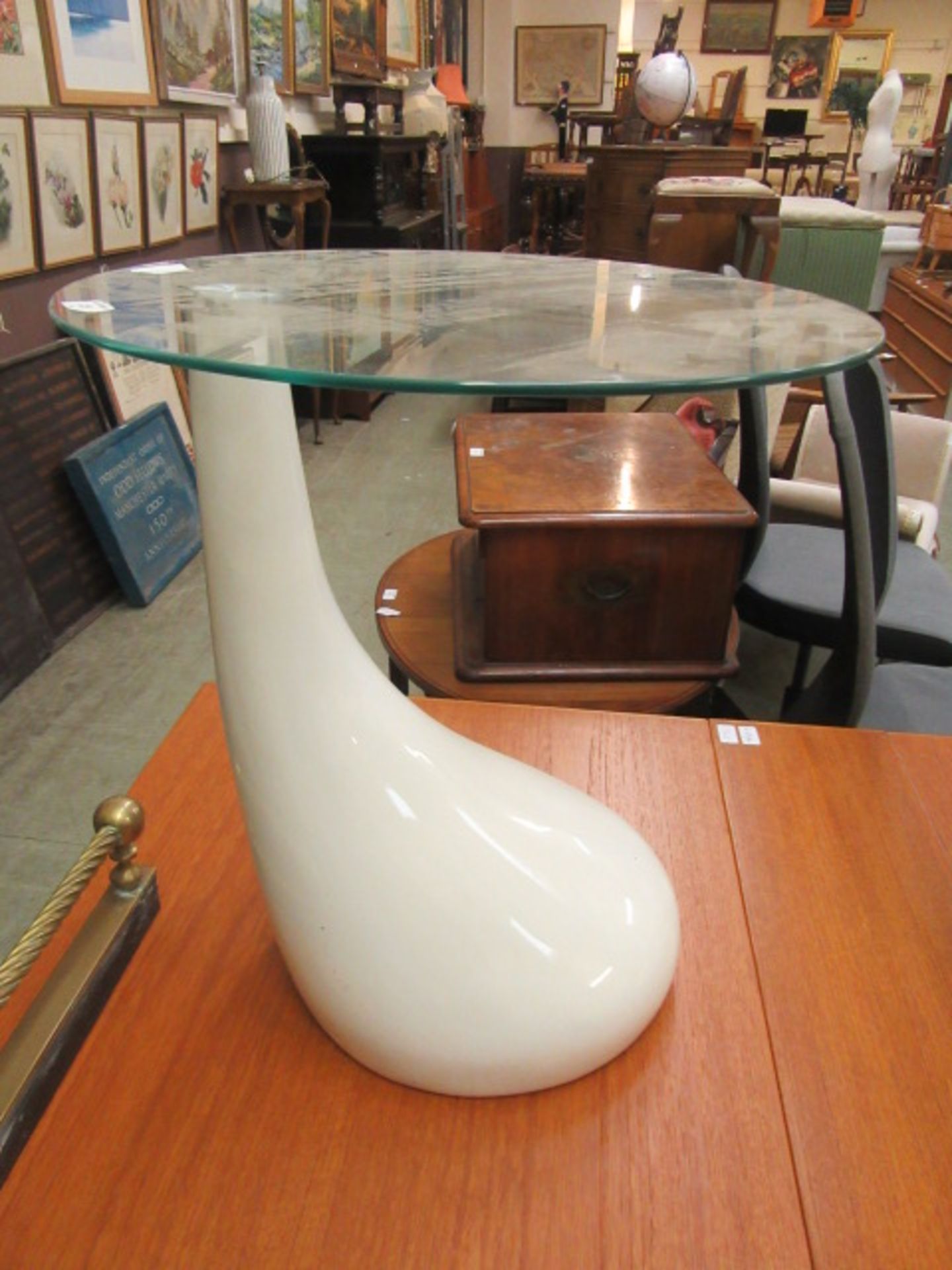 A mid-20th century design white Perspex occasional table with a circular glass top