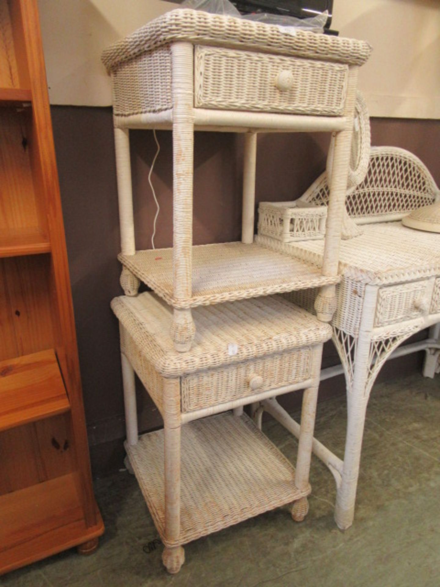 A pair of white painted wicker bedside cabinets